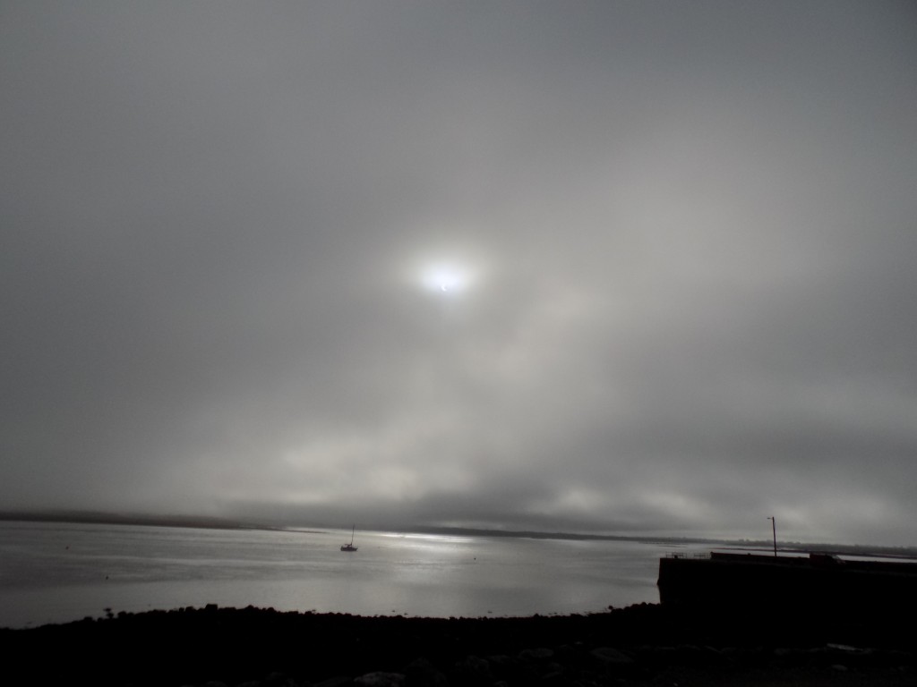 The eclipse over a fishing boat in Galway Bay